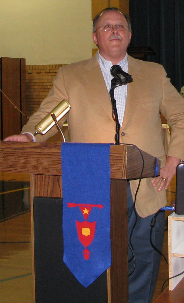 Jamie Ryan speaking at a podium
